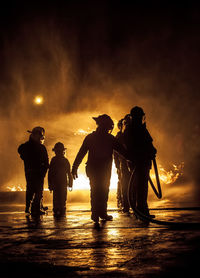 Silhouette of firefighters