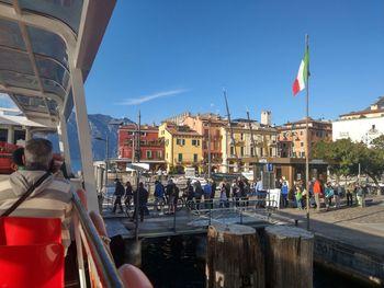 Group of people in city against buildings