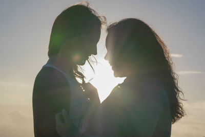 Man and woman against sky