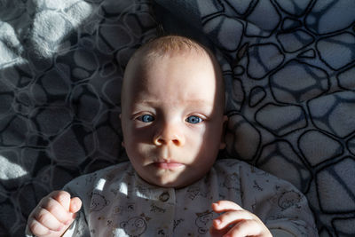 Little child with blue eyes lioks in camera