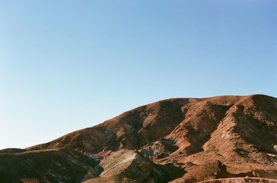 Low angle view of mountain against clear blue sky