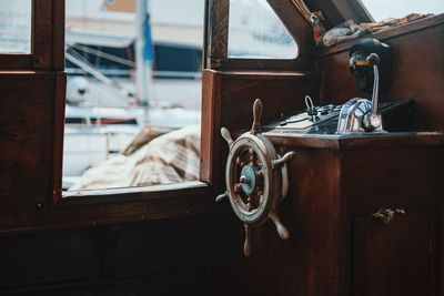 Steering wheel in boat at harbor