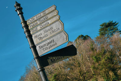 Low angle view of road sign against sky