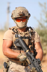 Portrait of soldier standing on field