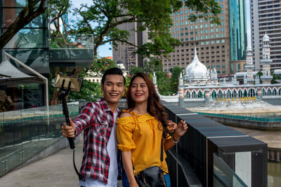 Portrait of smiling young woman in city