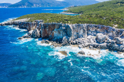 Scenic view of rocks on sea shore