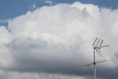 Low angle view of windmill against sky