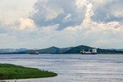Scenic view of river congo with container ships against sky, democratic republic of congo