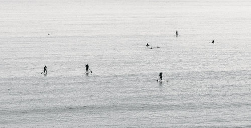 People sailing at calm sea