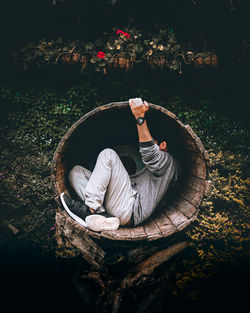 High angle view of senior man sitting by tree