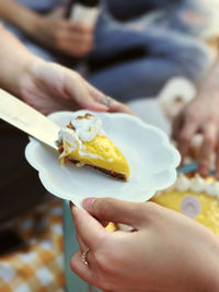 Cropped hand of woman holding ice cream