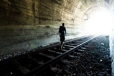 Man walking on railroad track