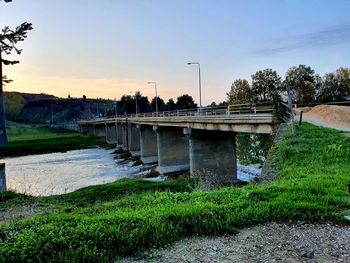 Bridge over field against sky