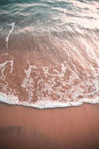 High angle view of waves rushing towards shore