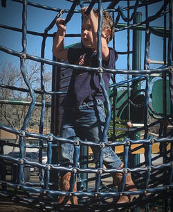 Full length of man standing on slide at playground