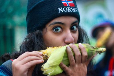 Close-up portrait of young woman eating food