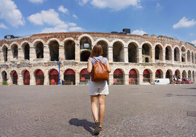 Rear view of woman standing against sky