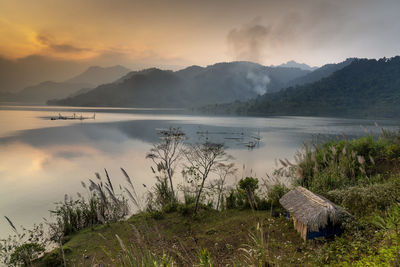 Scenic view of lake against sky during sunset