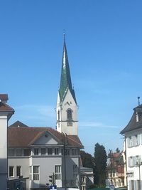 Low angle view of buildings against clear blue sky