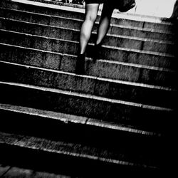 Low section of woman standing on tiled floor