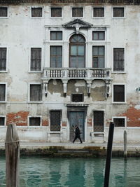 Man standing by building in city