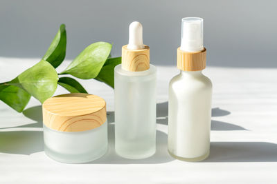 Set of frosted glass cosmetic bottles on white background. dropper bottle and cream jar package. 