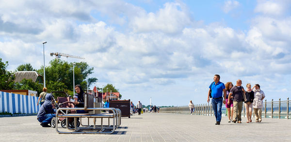 Panoramic view of people at park against sky