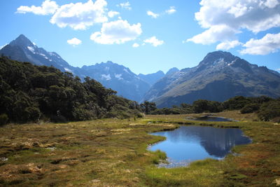 Scenic view of lake and mountains against sky