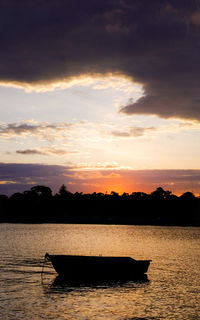 Boat in sea at sunset