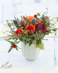 Close-up of red rose in vase on table