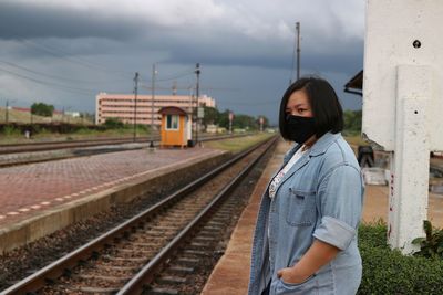 Side view of woman standing on railroad station platform