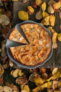 Homemade apple pie with autumn leaves. aesthetic food background
