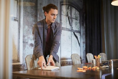 Young man sitting on table