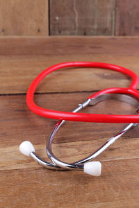 Close-up of stethoscope on wooden table