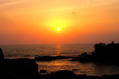 Scenic view of sea against romantic sky at sunset