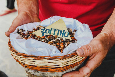 Midsection of man holding food in basket