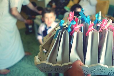 Cropped hand holding tray with tied up paper bag during event