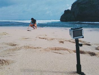 Man standing on beach against sky