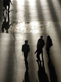 High angle view of silhouette people walking on floor