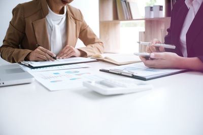 Close-up of business colleagues working in office