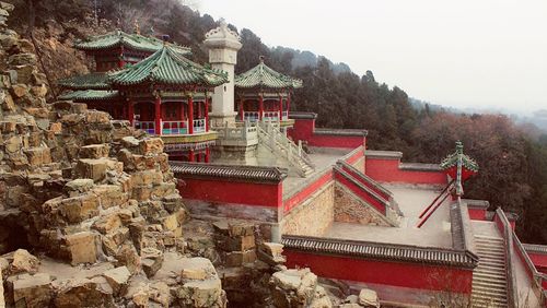 Low angle view of steps and mountain against sky during winter