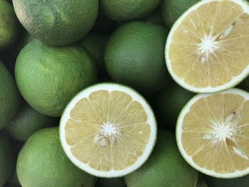 Full frame shot of many fresh sweet oranges and some cut in a half