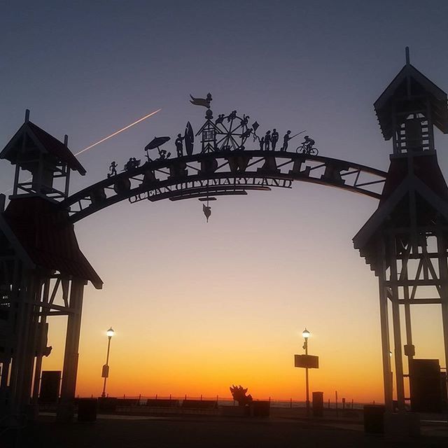 sunset, built structure, clear sky, architecture, building exterior, silhouette, orange color, sky, low angle view, outdoors, copy space, dusk, no people, nature, religion, protection, sunlight, street light, guidance, sun