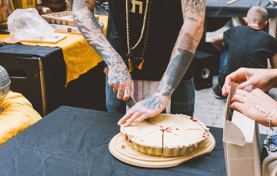 People holding food on table