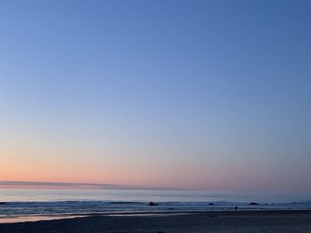 Scenic view of sea against clear sky during sunset