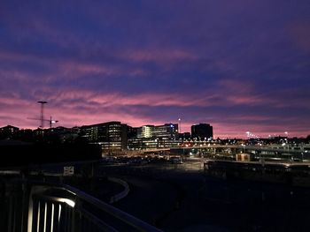 High angle view of illuminated buildings against sky at sunset