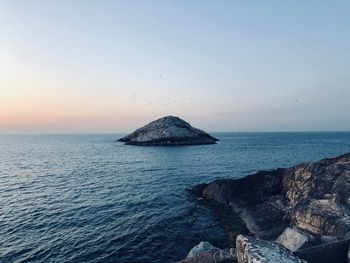 Scenic view of sea against clear sky during sunset