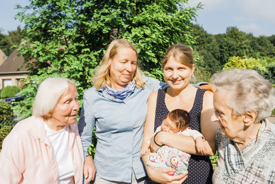 Family against plants in summer