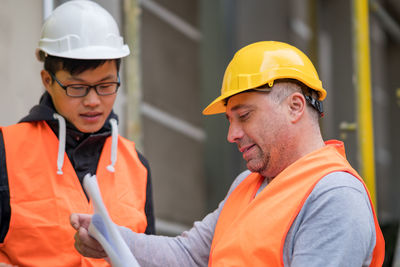 Close-up of men working at construction site