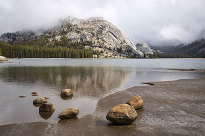 Scenic view of lake by mountains against sky